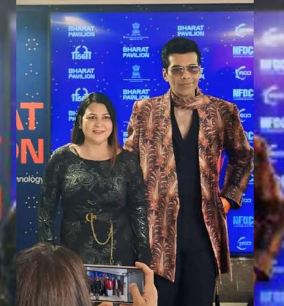 Woman and man at a media event.